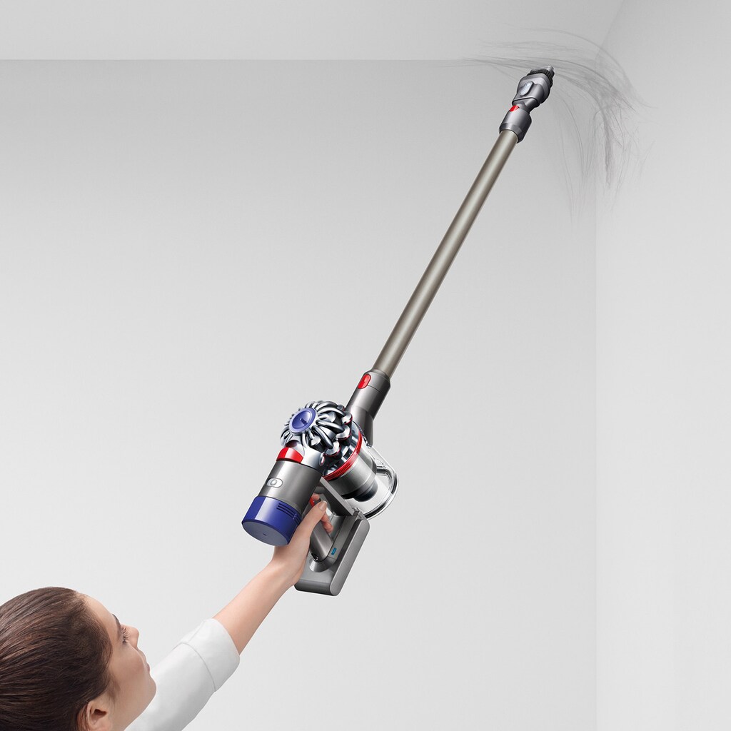 woman vacuuming cobwebs