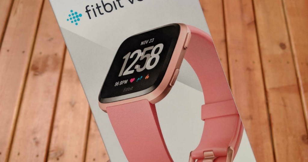 hand holding Fitbit Versa box