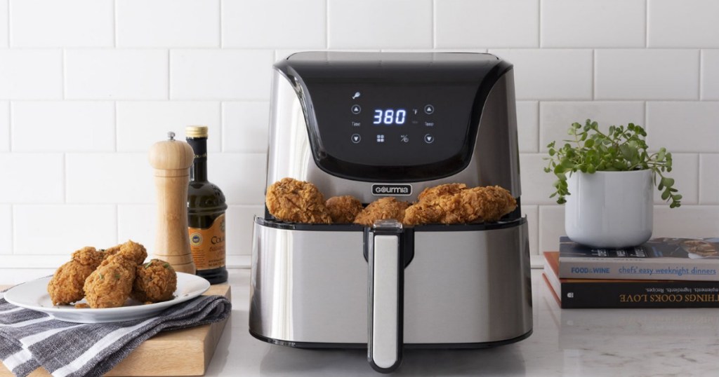 Gourmia 6-qt. Stainless Steel Digital Air Fryer full of fried chicken on counter