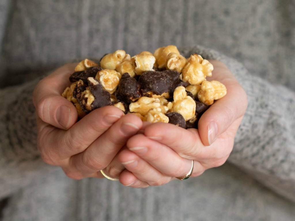 Woman holding a handful of premium popcorn