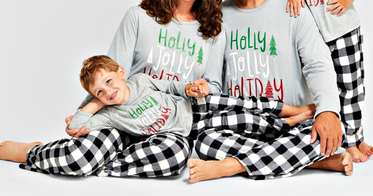 family wearing holiday buffalo check fleece pajama pants and matching shirts