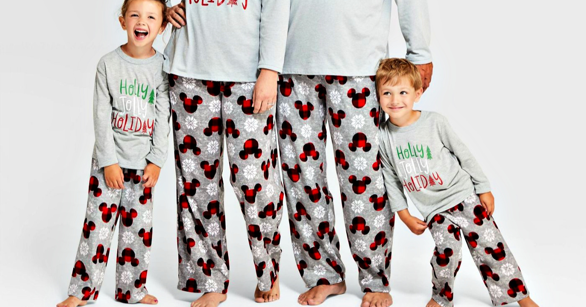 family wearing holiday Mickey Mouse fleece pajama pants