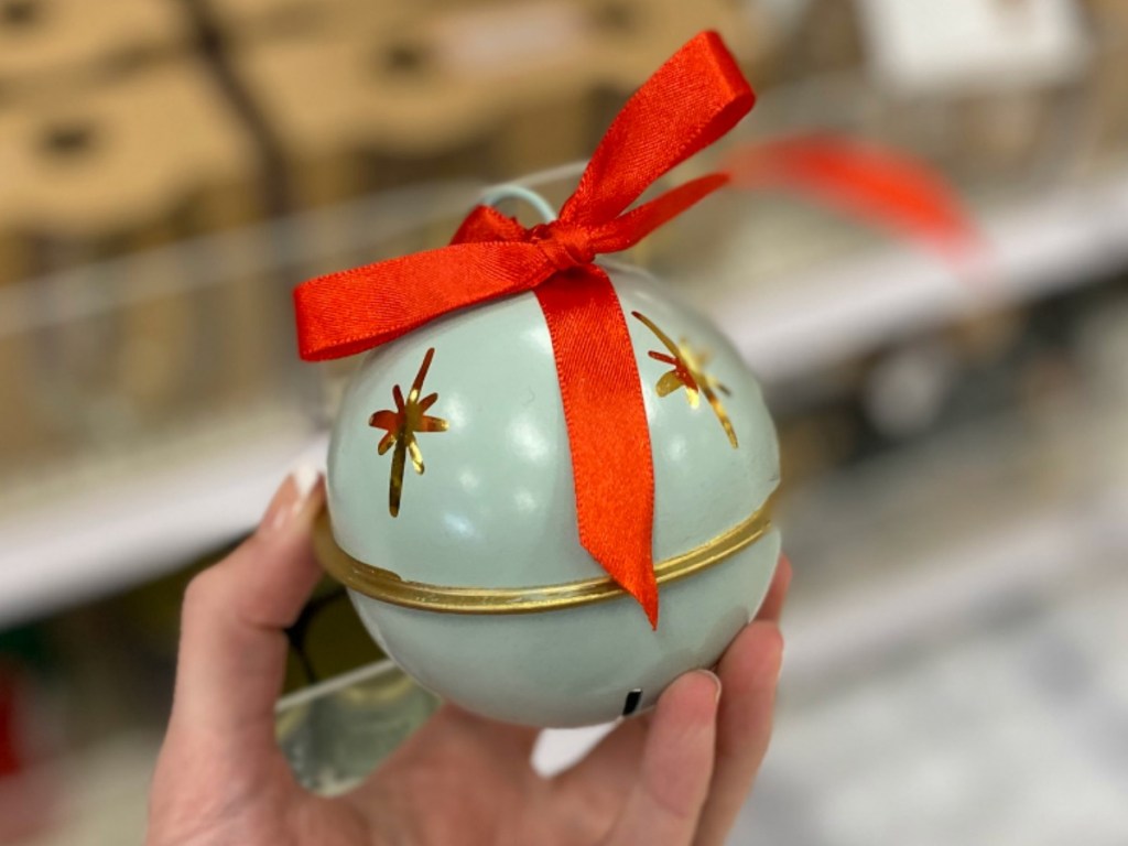 Green Jingle Bell ornament in hand in Target