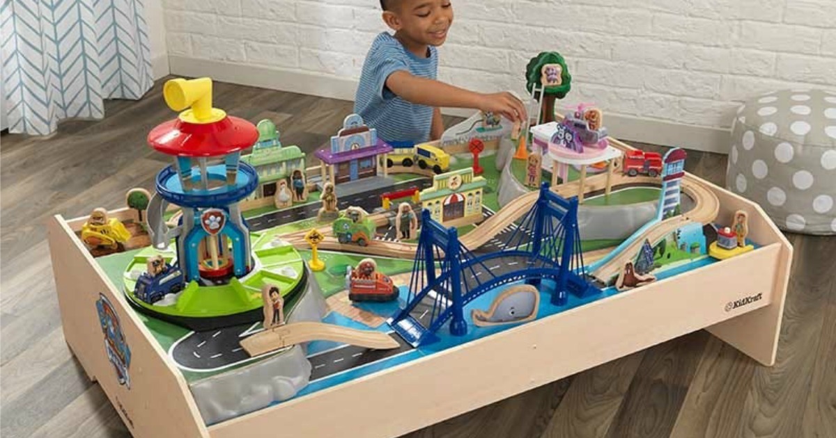 boy playing with KidKraft Paw Patrol Train Table