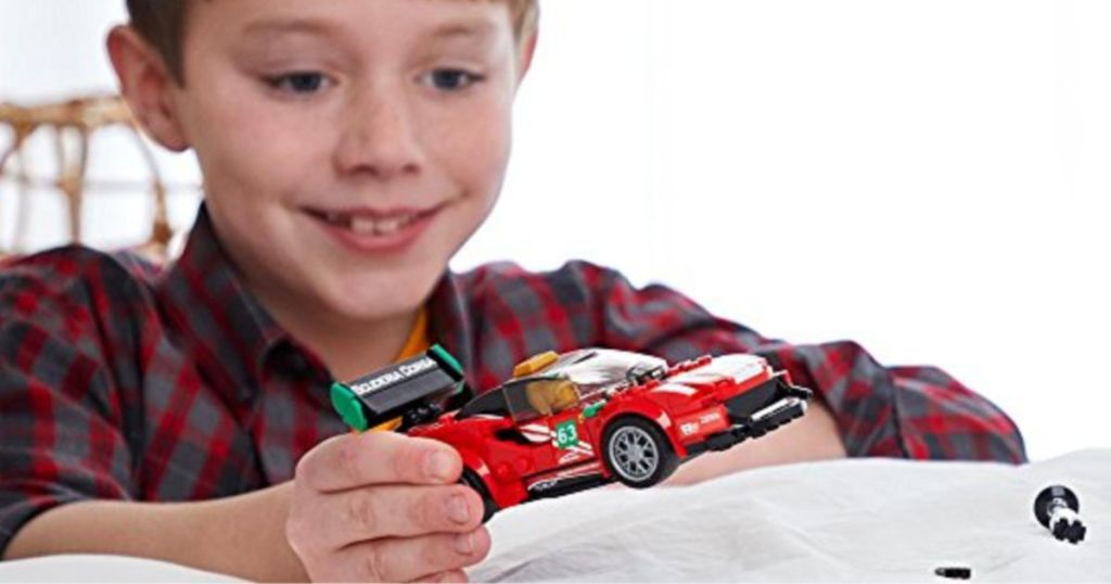 Boy playing with LEGO Speed Champions Ferrari