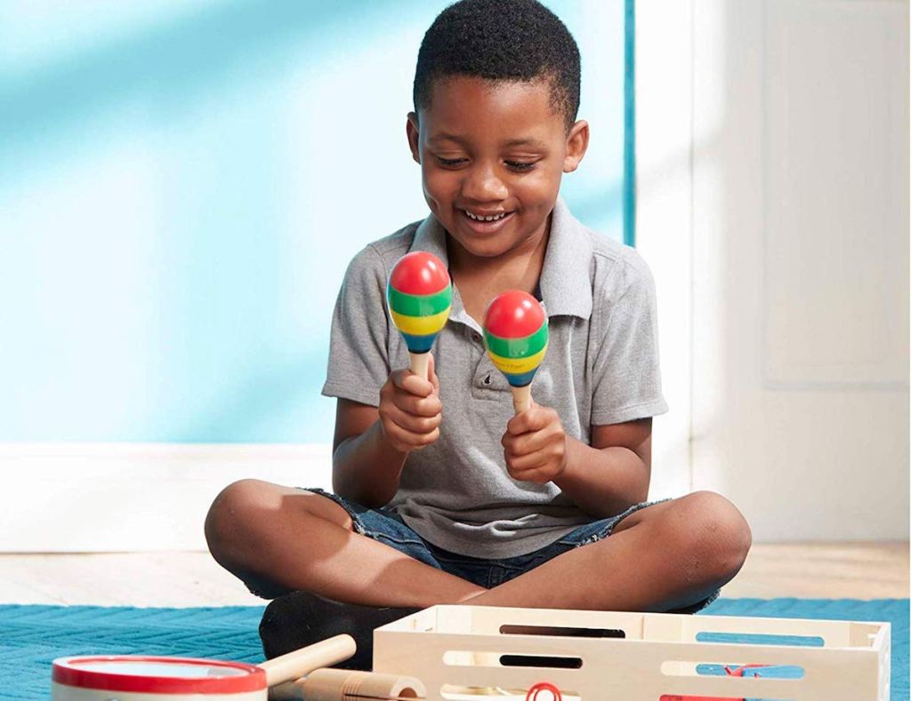 boy playing with Melissa & Doug Band In A Box set