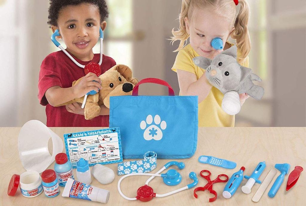 kids playing with Melissa & Doug Examine & Treat Pet Vet Play Set