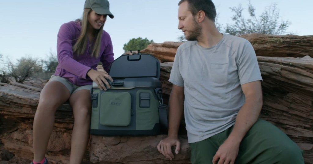 couple looking inside Otterbox Trooper Cooler 20 quart