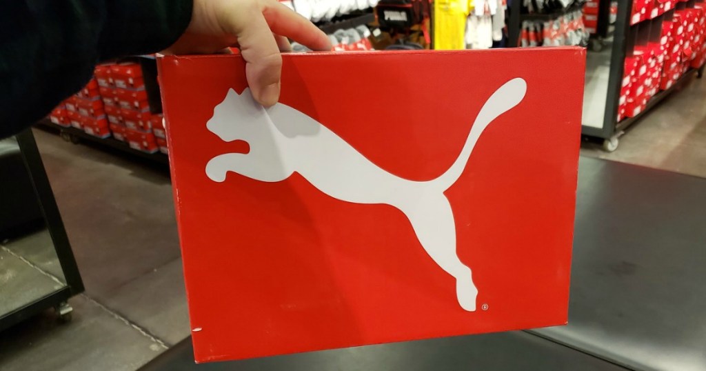 Hand holding a PUMA Shoe box