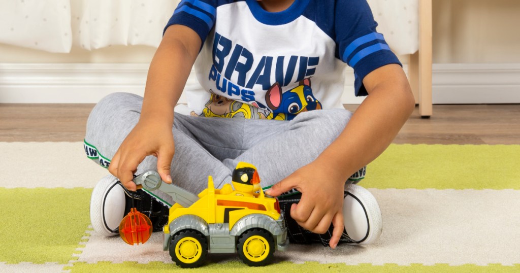 boy playing with paw patrol rubble vechicle