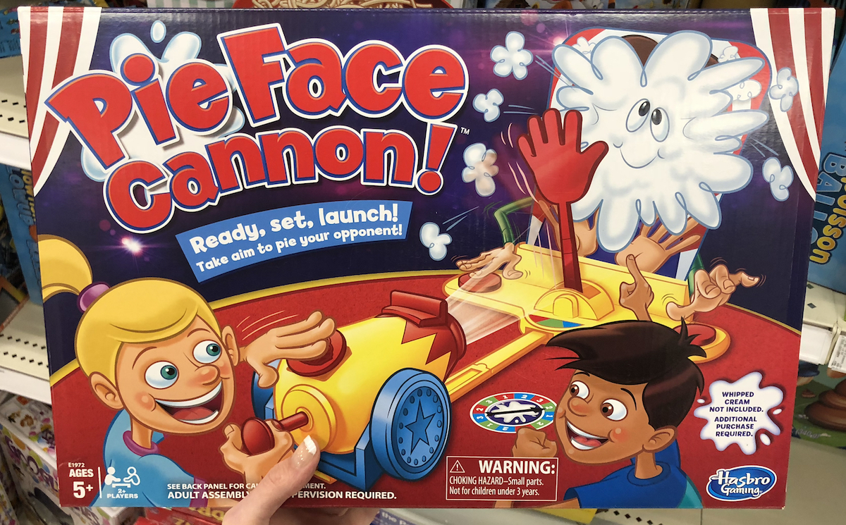 hand holding Pie Face Cannon game box