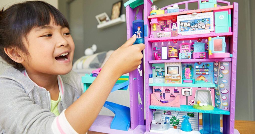 girl playing with Polly Pocket Mega Mall using elevator