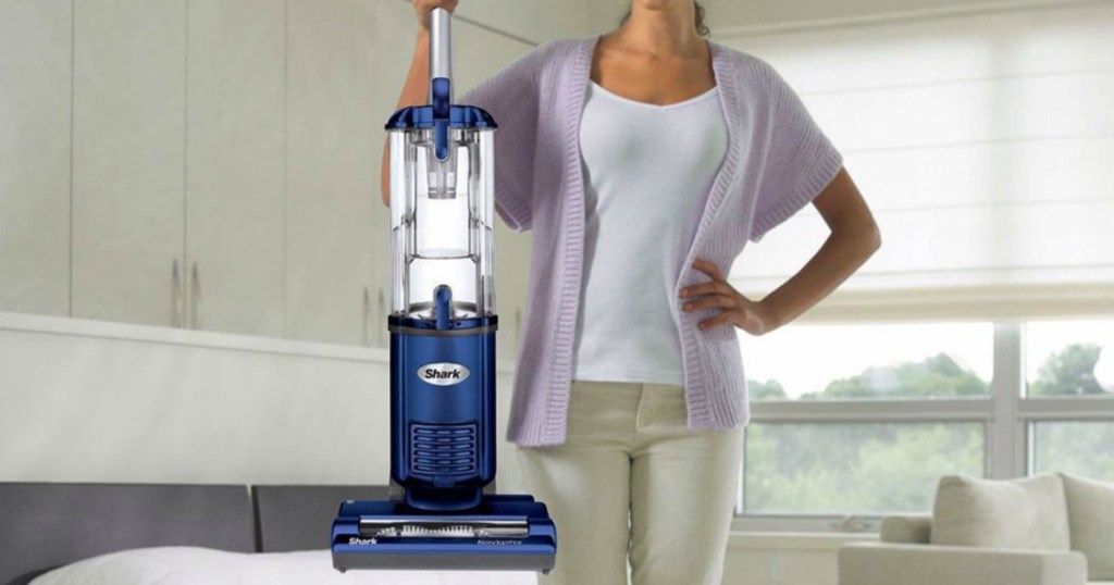 Woman holding a blue Shark Upright & Canister Upright Vacuum