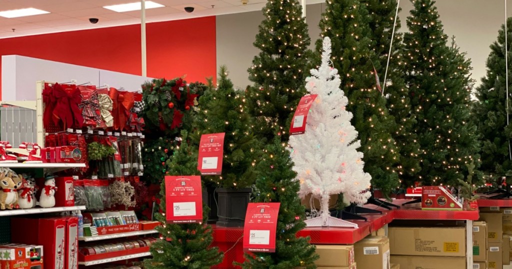 artificial christmas trees on display in a store