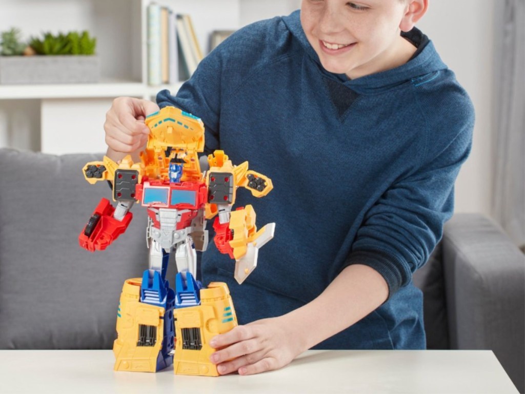 boy playing with robot transformer