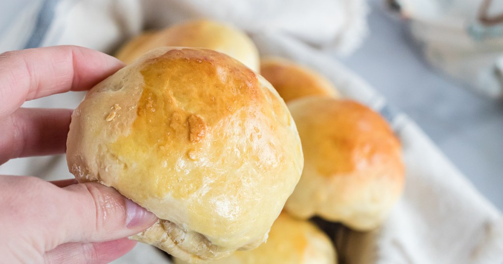 holding a dinner roll