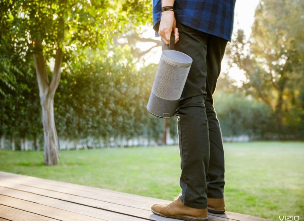 man holding a portable speaker