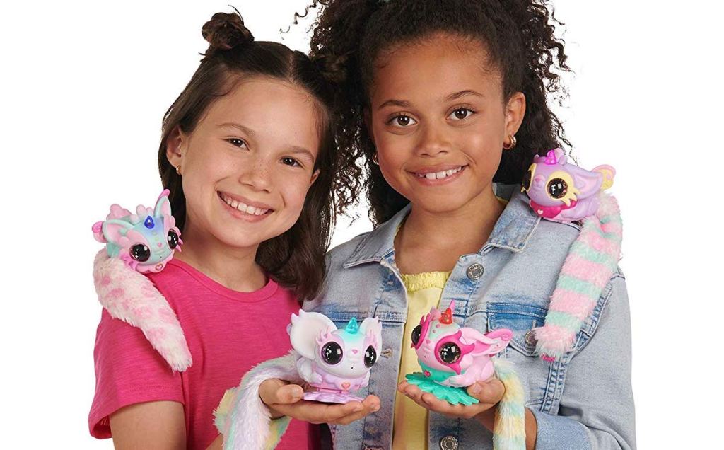 girls holding WowWee Pixie Belles Interactive Enchanted Animal Toy