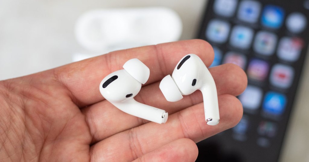 Apple Airpods Pro in hand near phone