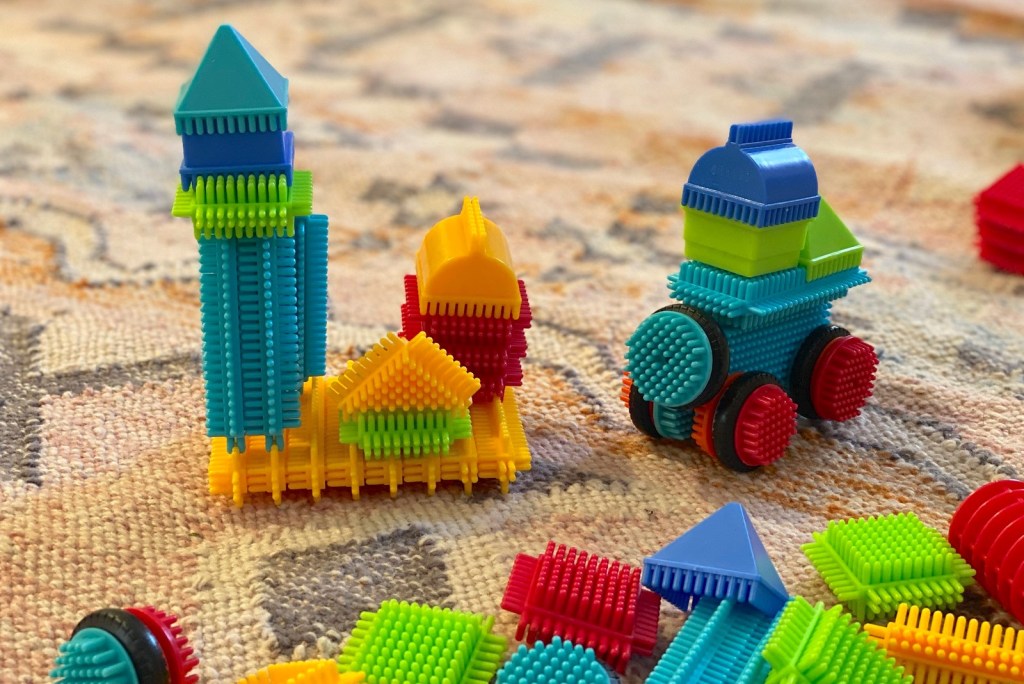 colorful bristle blocks with shapes on floor 