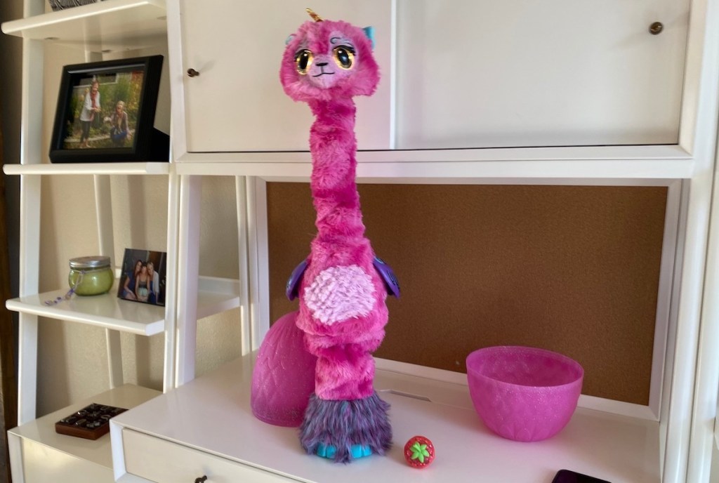 pink hatchimal WOW toy sitting on white desk 