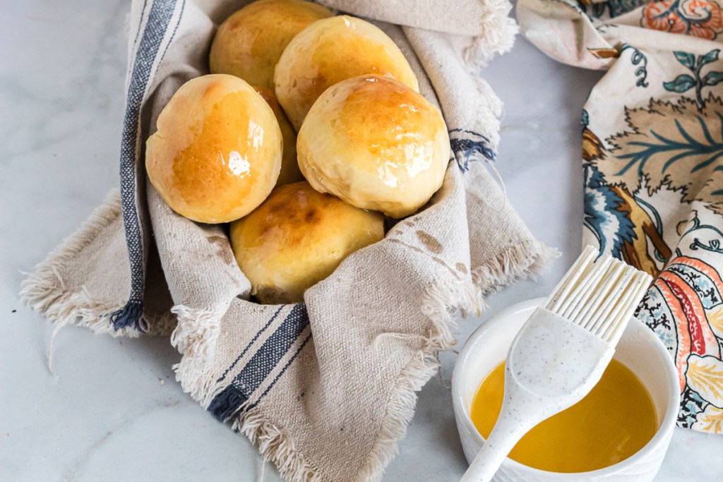 finished dinner rolls with honey butter ontop