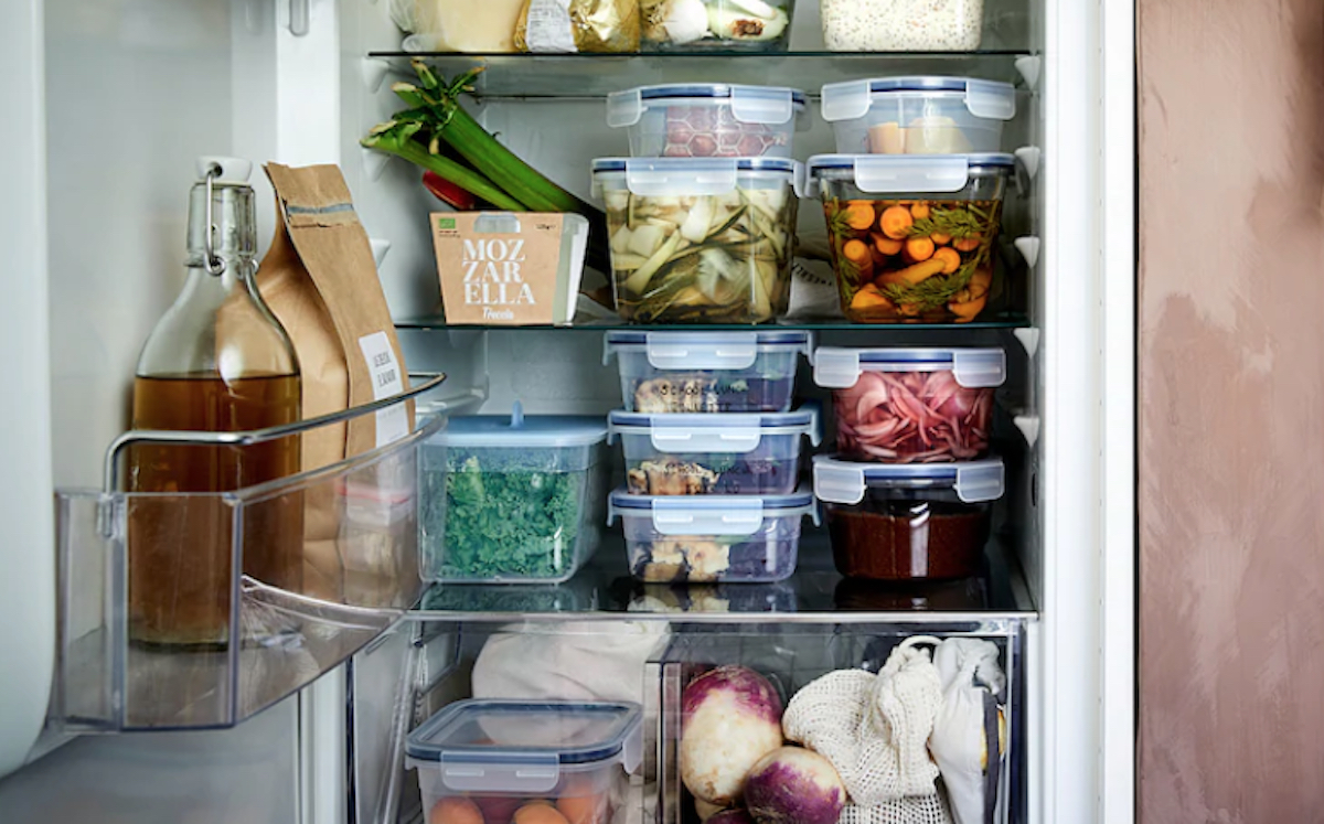 refrigerator with stacked glass containers inside 