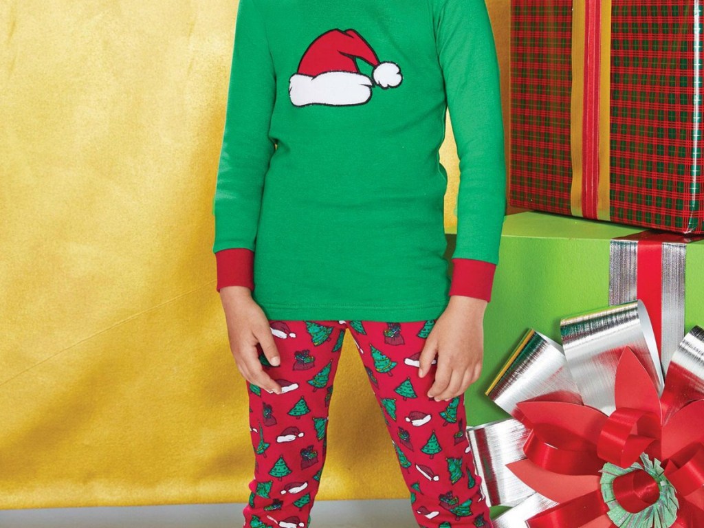 kid wearing red and green pajamas