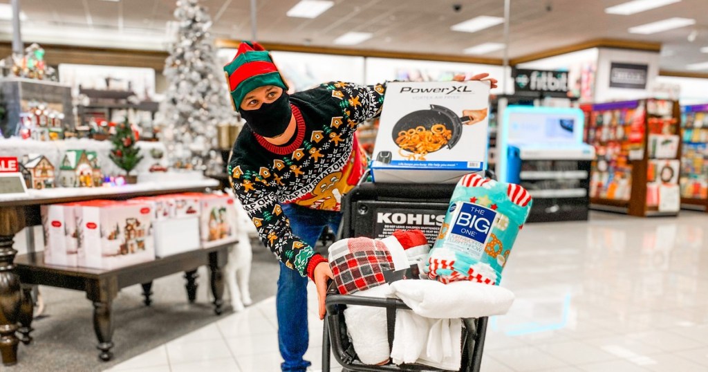 man wearing mask and Christmas hat pushing cart at Kohl's