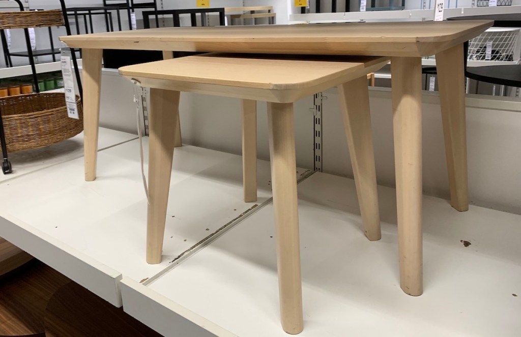 small natural colored wood side tables on store shelf 