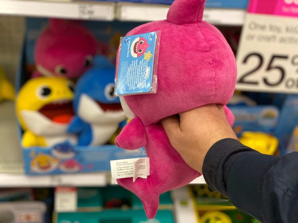 hand holding a pink baby shark 