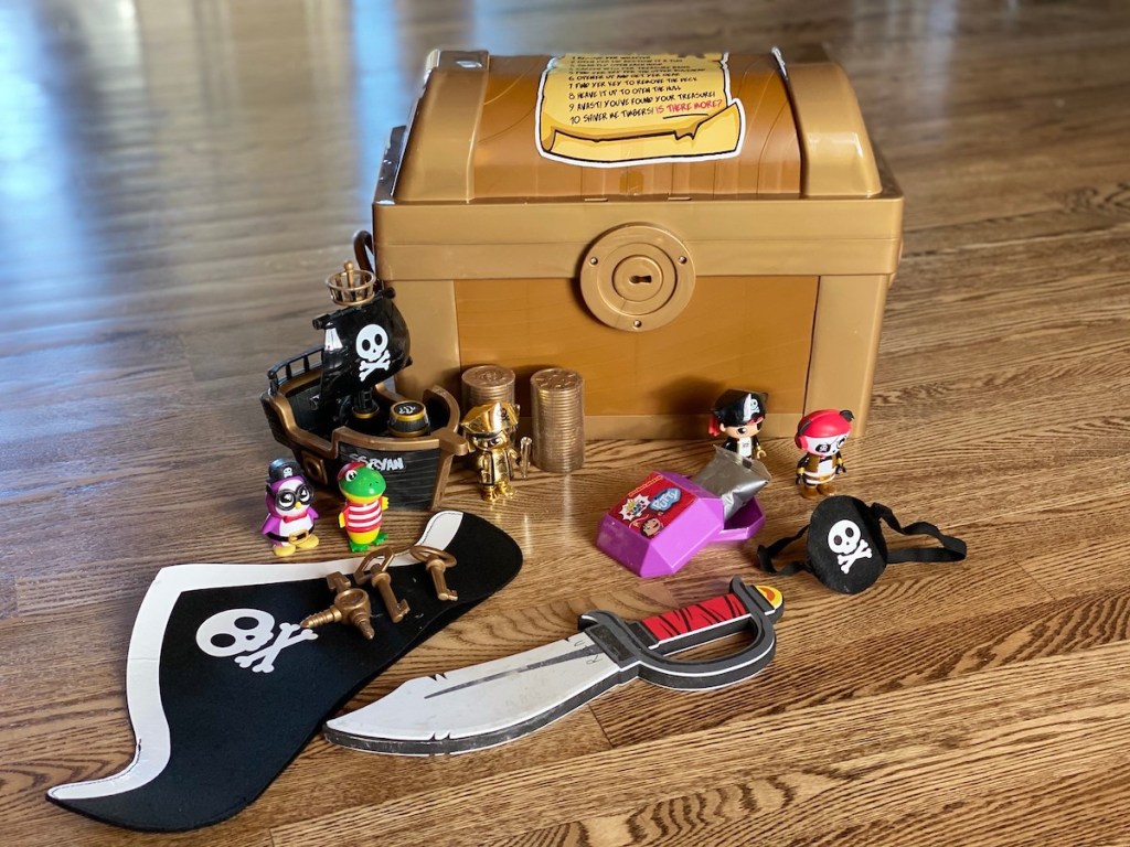 ryans treasure chest with plastic toys on wood floor