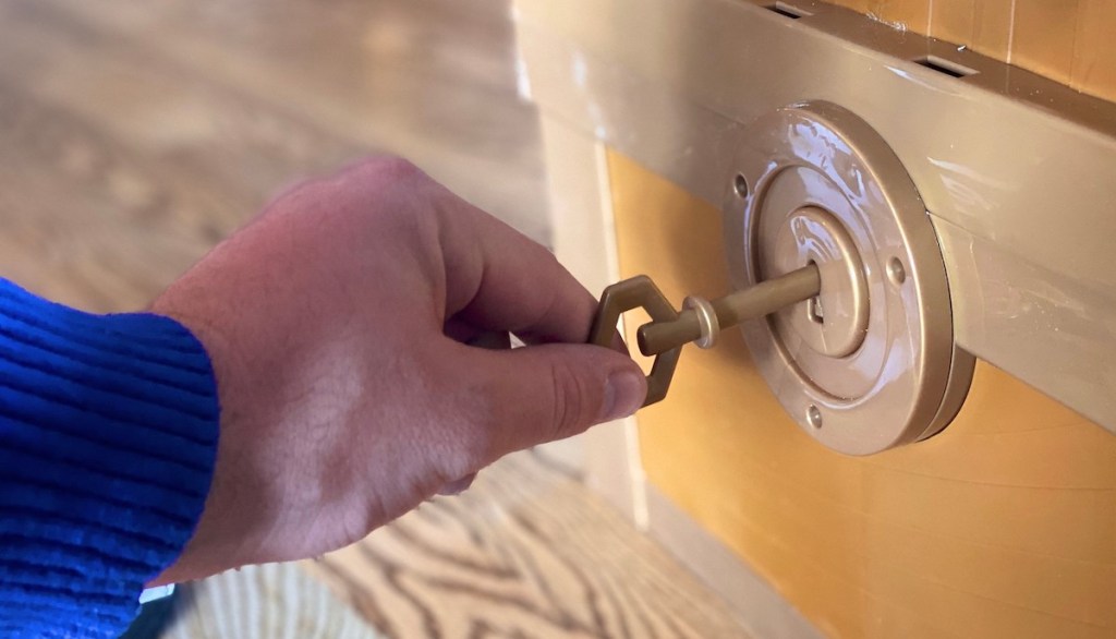 hand using plastic skeleton key for ryans world toy chest 