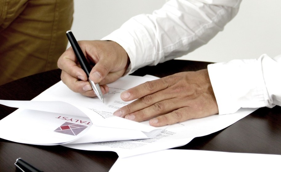 man signing packet of papers ways to make extra money