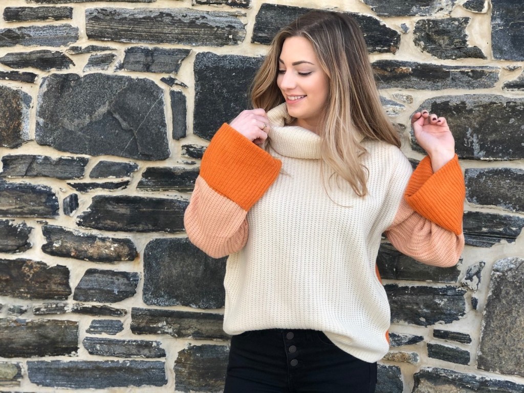 woman wearing a beige and orange sweater 