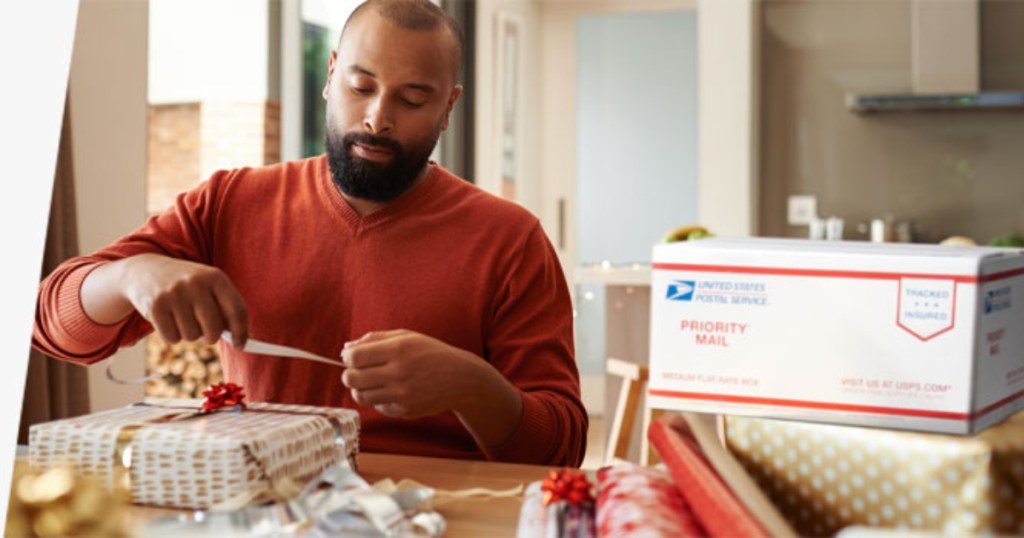 Man wrapping gift to ship via USPS