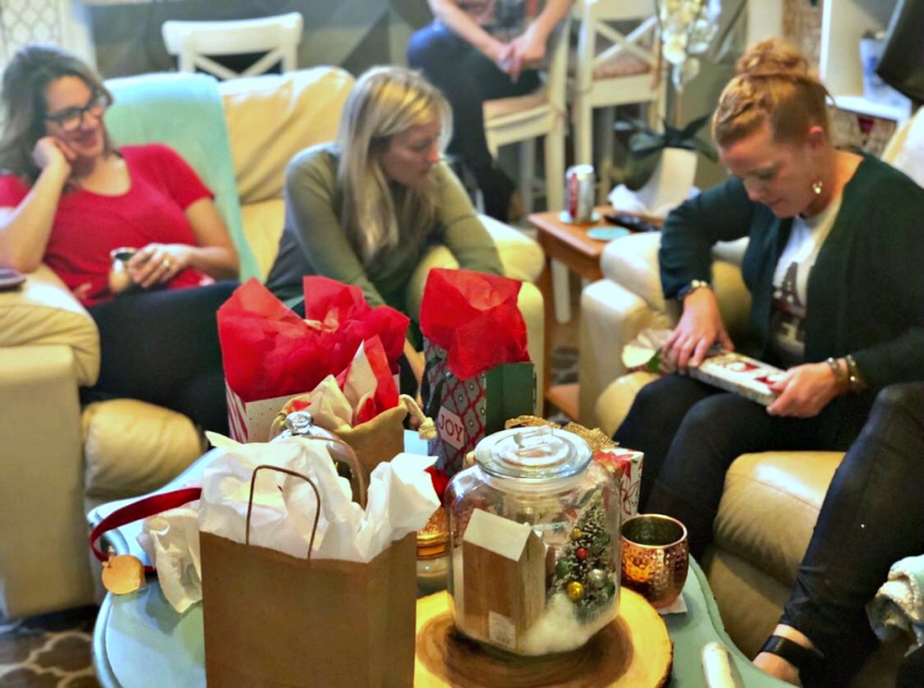 woman opening white elephant gifts