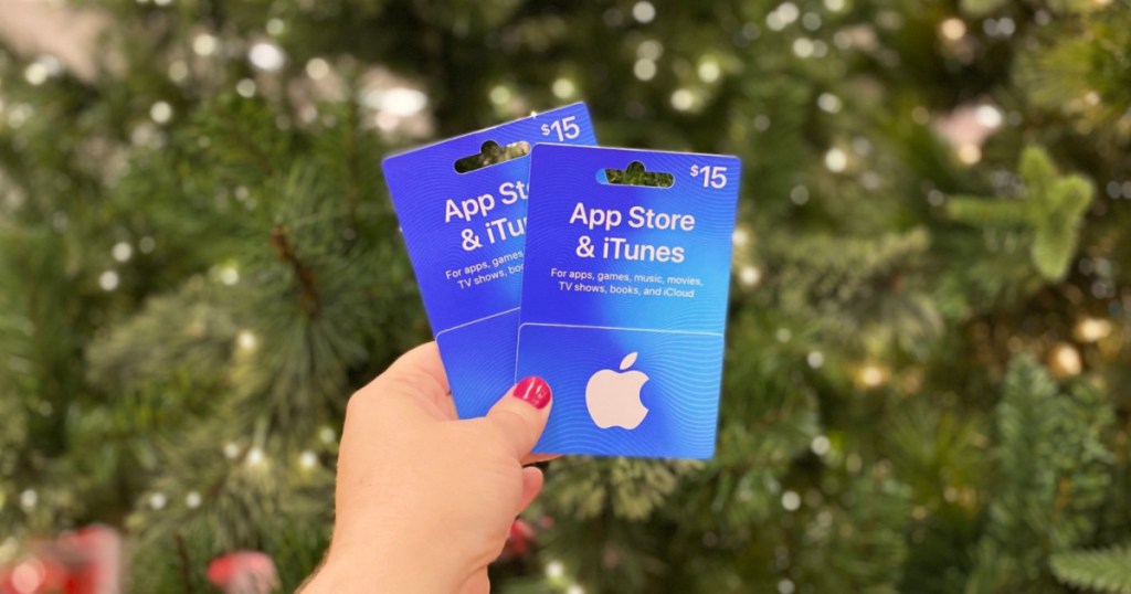 hand holding up two app store itunes gift cards