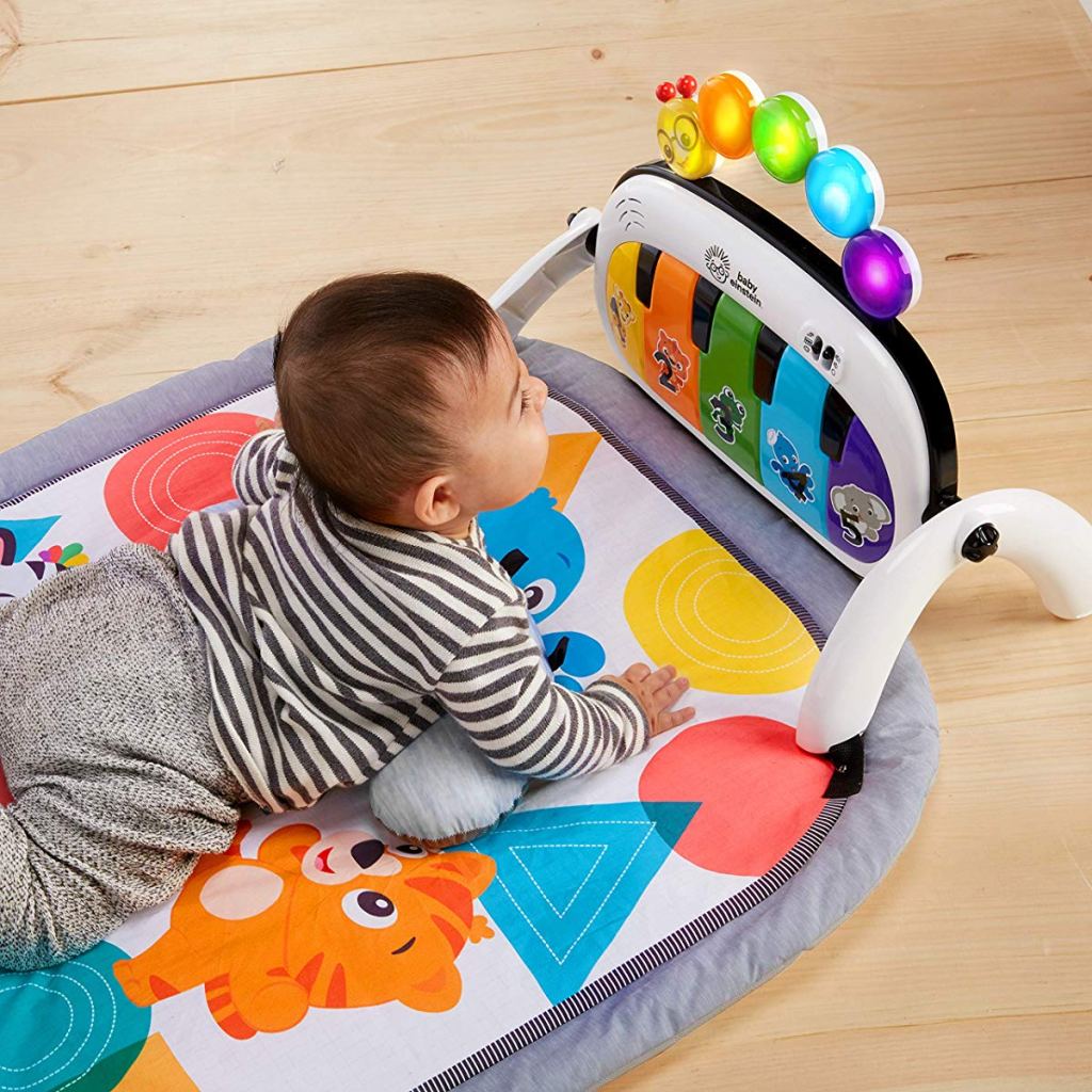 baby laying on a Baby Einstein 4-in-1 Kickin' Tunes