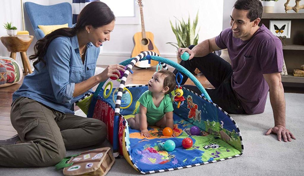 baby and parents playing in Baby Einstein 5-in-1 Journey of Discovery Activity Gym