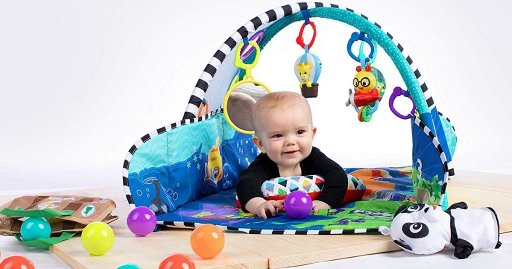 baby laying on a Baby Einstein Activity Mat