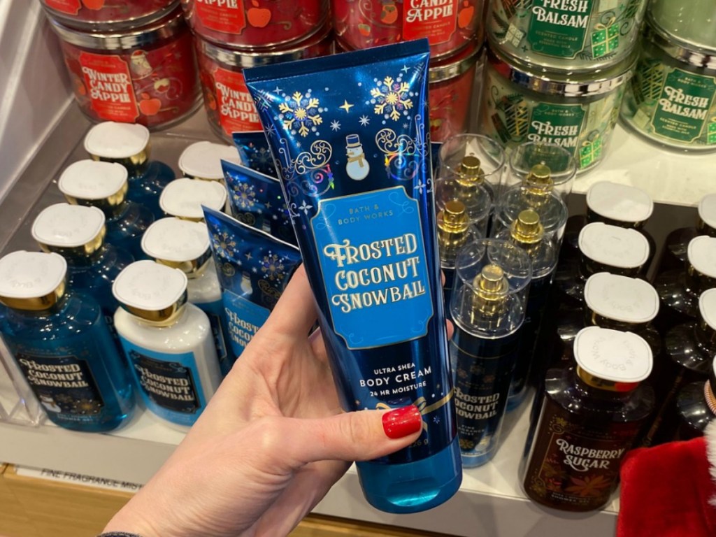 Tube of holiday scented body lotion in hand