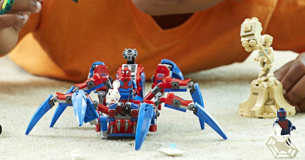 Little boy playing with Spiderman Crawler Lego Set 