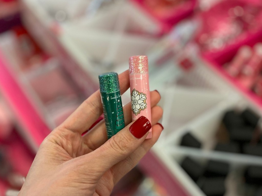 Hand holding two ULTA lip balm stocking stuffers