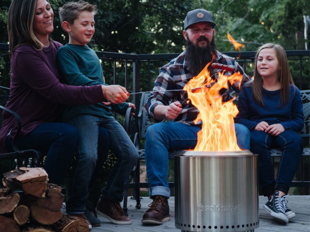 Family sitting around Solo Campire Stove