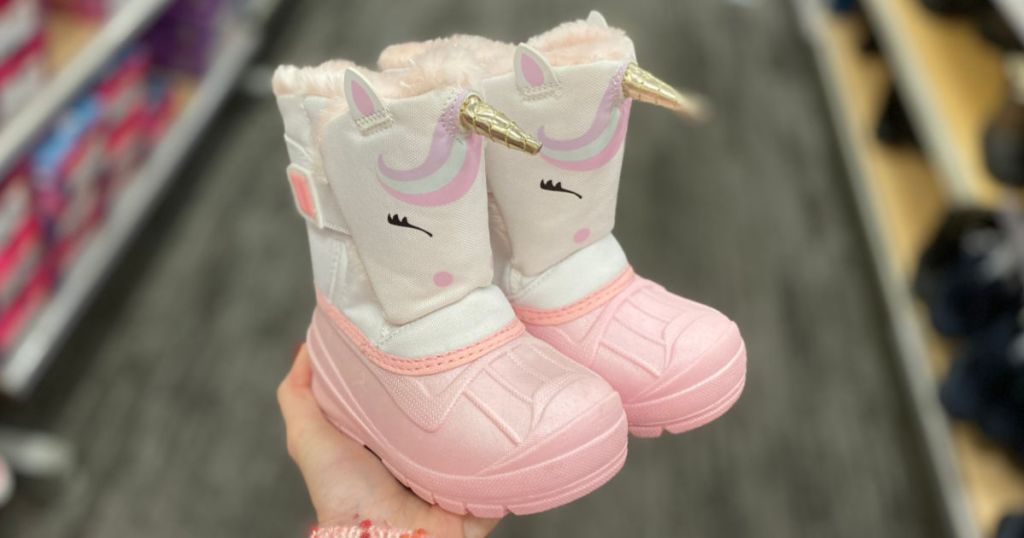 woman hand holding Cat & Jack Toddler Girls Huxley Winter Boots in store