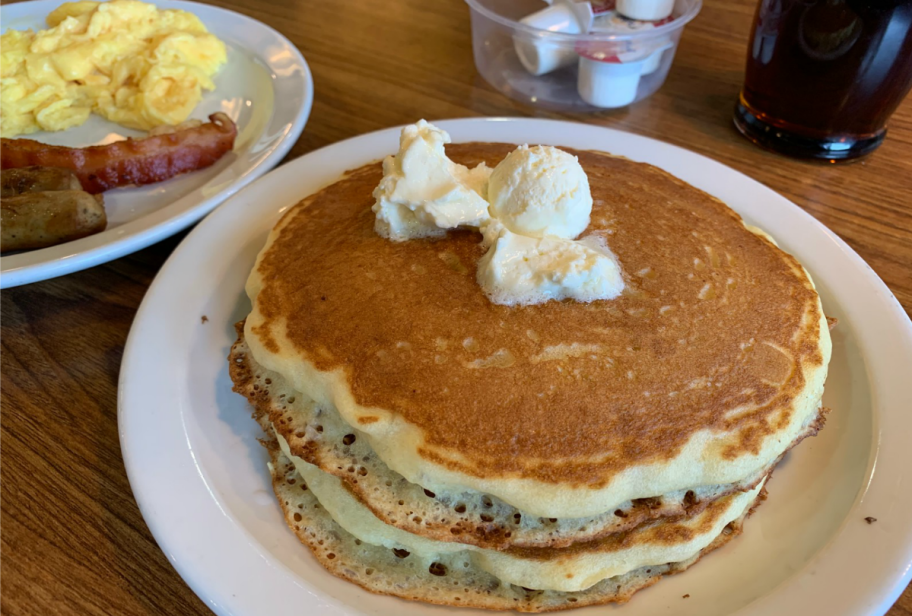 Denny's pancakes on the table with eggs