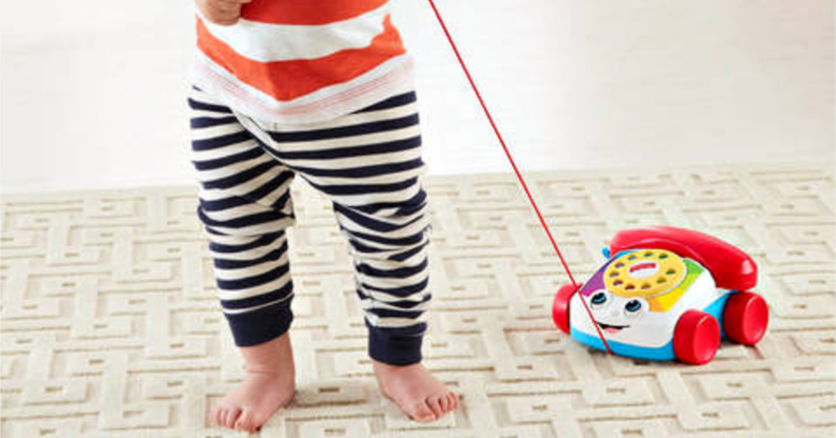 toddler playing fisher price chatter telephone