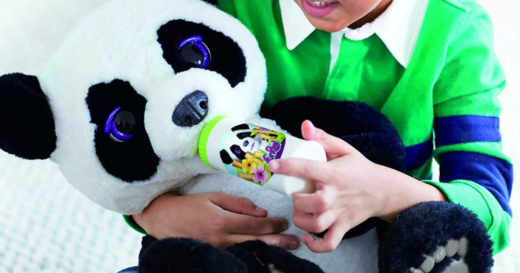 Boy playing with a FurReal Plum The Curious Panda Bear