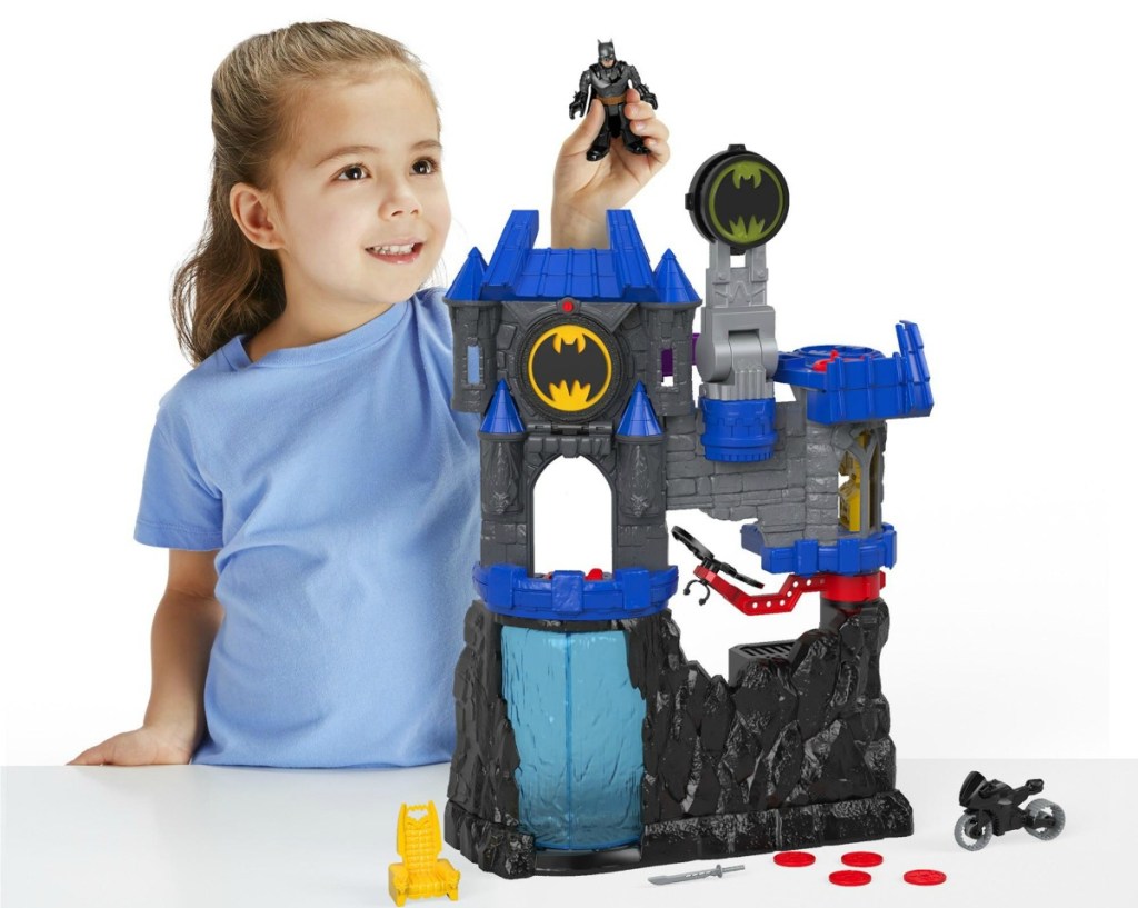 Girl playing with Imaginext DC Super Friends Wayne Manor Batcave